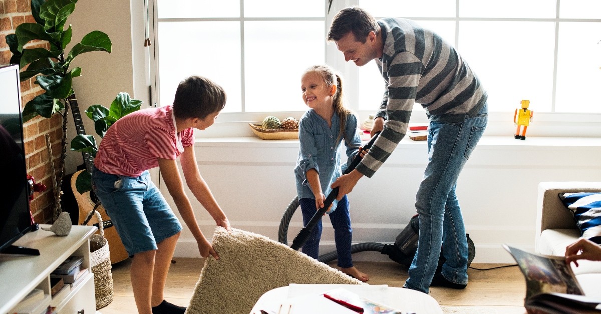 husband and kids vacuuming for mom