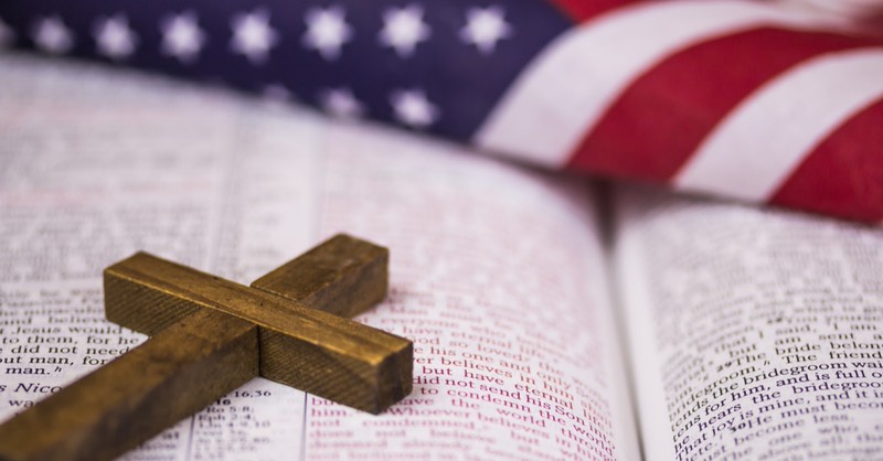 A cross the Bible and the American flag, most practicing Christians think America is blessed by God
