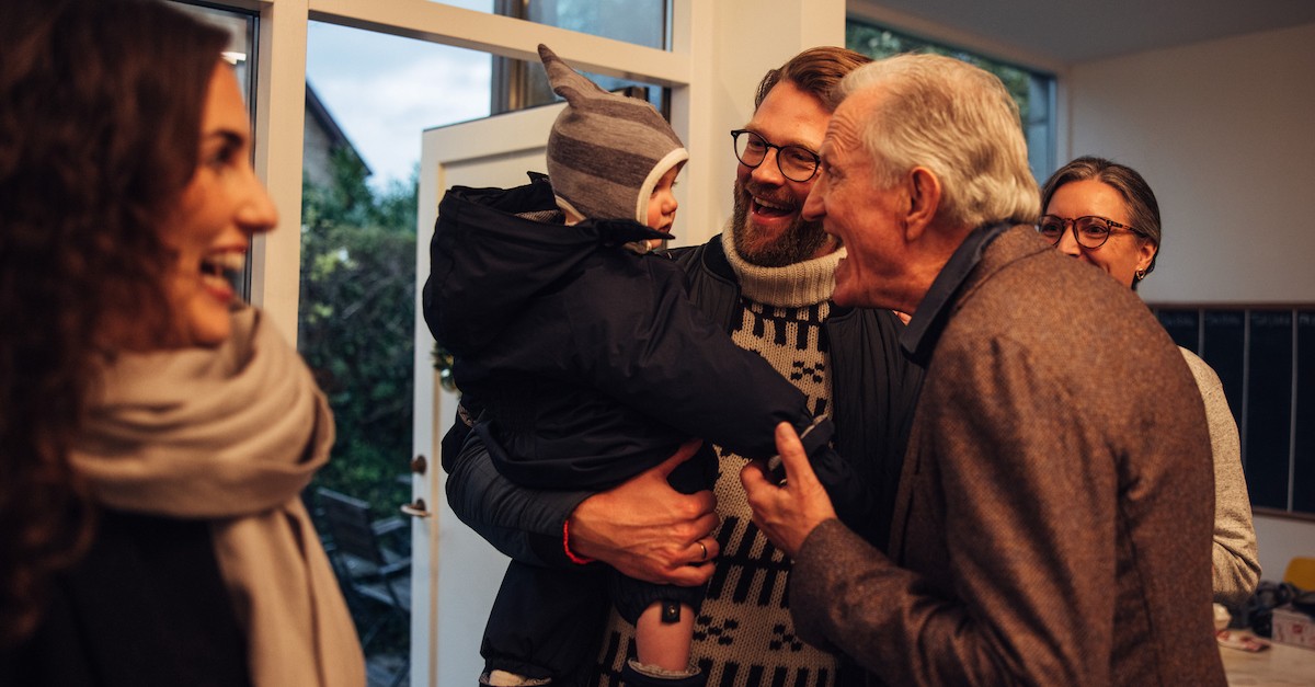 Happy family hosting holiday gathering thanksgiving or christmas grandparents and kid